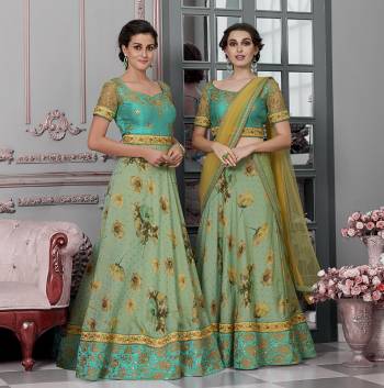 As Per Your Convinince And Occasion, Get This Two-In-One Dress Stitched As Lehenga Or Suit. Its Pretty Blouse Is Fabricated On Art Silk And Net Paired with Modal Silk Fabricated Lehenga And Net Fabricated Dupatta. It Is Beautified With Bold Floral Prints With Embroidery. Also Its Fabrics Ensures Superb Comfort All Day Long. 