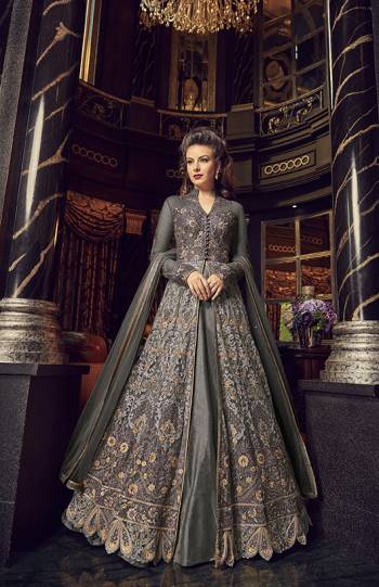 Flaunt Your Rich And Elegant Taste In This Designer Indo-Western Suit In Dark Grey Color. Its Top And Dupatta Are Net Based With Heavy Embroidery, Available With A Lehenga And Embroidered Pants. Its Lehenga And Pants Are Fabricated On Art Silk. You Can Pair With Any Of Them As Per The Occasion.