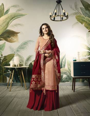 A Must Have Shade In Every Womens Wardrobe Is Here With This Designer Straight Plazzo Suit In Peach Colored Top Paired With Contrasting Maroon Colored Bottom And Dupatta. Its Pretty Embroidred Top Is Fabricated On Satin Silk Paired With Santoon Bottom And Banarasi Silk Fabricated Dupatta. 