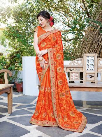 Shine Bright In This Designer Orange Colored Saree Paired With Orange Colored Blouse. This Saree Is Georgette Based Paired With Art Silk Fabricated Blouse Beautified With Contrasting Thread Embroidery And Stone Work