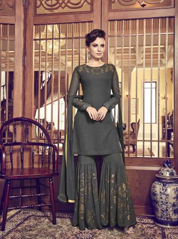 Flaunt Your Rich And Elegant Taste Wearing This Designer Sharara Suit In Dark Grey Color. Its Top, Bottom And Dupatta Are Fabricated On Georgette Based Beautified With Attractive Stone Work All Over It. Buy This Semi-Stitched Suit Now.