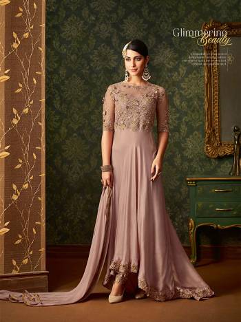 Get Ready For The Upcoming Wedding Season With This Beautiful Designer Suit Dusty Pink Color. Its Top Is Fabricated On Silk Georgette And Net Paired With Santoon Bottom And Chiffon Dupatta. Its Has Very Pretty Embroidered Yoke With High Low Pattern. Buy Now.