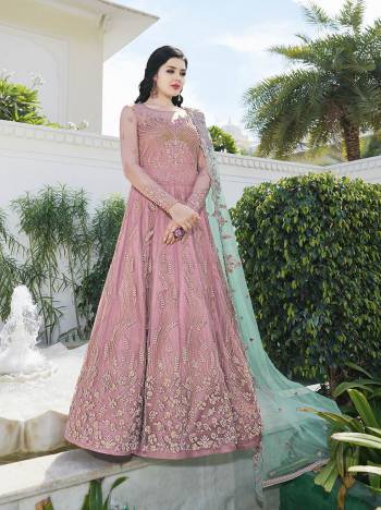 Look Pretty In This Designer Floor Length Suit In Pink Color Paired With Contrasting Aqua Blue Colored Dupatta. Its Heavy Embroidered Top Is Fabricated On Net Paired With Satin Bottom And Net Fabricated Dupatta. Buy Now.