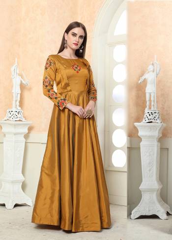 Celebrate This Festive Season with Beauty And Comfort Wearing This Designer Light Weight Readymade Gown In Musturd Yellow Color. This Silk based Gown Is Beautified With contrasting Embroidery Over the Yoke And Sleeves. Buy Now.