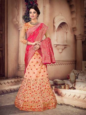 You Will Definitely Earn Lots Of Compliments Wearing This Heavy Designer Lehenga Which Has Two Dupatta Concept. This Heavy Embroidered Lehenga Choli Is Silk Based Paired With One Jacquard Silk Dupatta And Another Net Fabricated Dupatta. All Its Fabrics And Color Pallete Will Also Give A Rich Look To Your Personality.