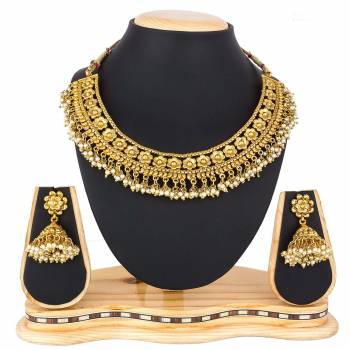 For A Queen Look, Here Is A Designer Royal Looking Necklace Set In Golden Color. This Necklace Set Can Be Paired With Heavy Ethnic Attire For More Enhanced Look. Buy Now