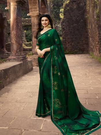 Celebrate This Festive Season With Beauty And Comfort Wearing This Light Weight Saree In Dark Green Color Paired With Dark Green Colored Blouse. This Saree Is Georgette Based Paired With Silk Based Blouse. It Is Beautified With Attractive Foil Prints. 