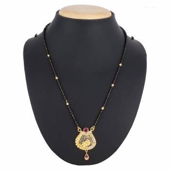 Here Is A Royal And Elegant Looking Magalsutra With A Pretty Delicate Chain And Heavy Golden Colored Pendant. This Mangalsutra Is Light In Weight And Can Be Paired With Any Colored Attire. Buy Now.