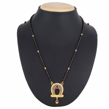 Here Is A Royal And Elegant Looking Magalsutra With A Pretty Delicate Chain And Heavy Golden Colored Pendant. This Mangalsutra Is Light In Weight And Can Be Paired With Any Colored Attire. Buy Now.