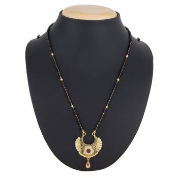 Here Is A Royal And Elegant Looking Magalsutra With A Pretty Delicate Chain And Heavy Golden Colored Pendant. This Mangalsutra Is Light In Weight And Can Be Paired With Any Colored Attire. Buy Now.