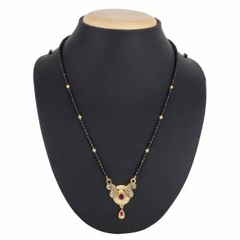 Here Is A Royal And Elegant Looking Magalsutra With A Pretty Delicate Chain And Heavy Golden Colored Pendant. This Mangalsutra Is Light In Weight And Can Be Paired With Any Colored Attire. Buy Now.