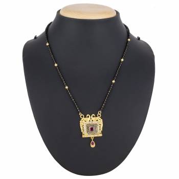 Here Is A Royal And Elegant Looking Magalsutra With A Pretty Delicate Chain And Heavy Golden Colored Pendant. This Mangalsutra Is Light In Weight And Can Be Paired With Any Colored Attire. Buy Now.