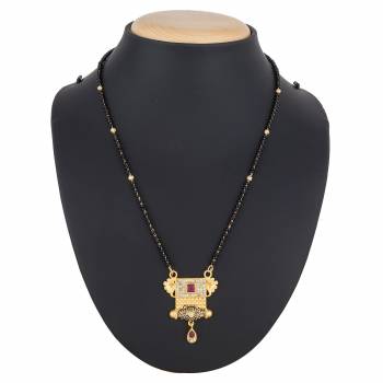 Here Is A Royal And Elegant Looking Magalsutra With A Pretty Delicate Chain And Heavy Golden Colored Pendant. This Mangalsutra Is Light In Weight And Can Be Paired With Any Colored Attire. Buy Now.