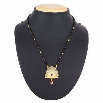 Here Is A Royal And Elegant Looking Magalsutra With A Pretty Delicate Chain And Heavy Golden Colored Pendant. This Mangalsutra Is Light In Weight And Can Be Paired With Any Colored Attire. Buy Now.