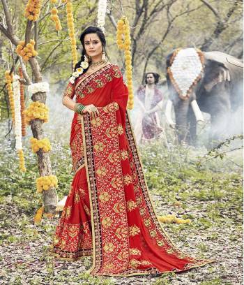 Here Is A Heavy Designer For The Upcoming Wedding Season In Red Color Paired With Red Colored Blouse .This Heavy Embroidered Saree IS Fabricated On Georgette Paired With Art Silk Fabricated Blouse. Buy This Now. 