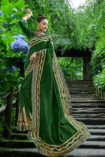 Here Is A Beautiful Saree In Dark Green Color Paired With Dark Green Colored Blouse. This Saree Is Fabricated On Silk Paired With Art Silk Fabricated Blouse. This Designer Saree IS Beautified With Attractive Embroidery. 