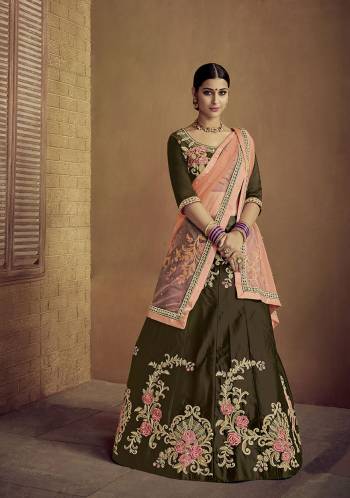 Enhance Your Personality Wearing This Heavy Designer Lehenga Choli In Dark Olive Green Color Paired With Contrasting Peach Colored Dupatta. Its Blouse And Lehenga Are Satin Silk Based Paired With Net Fabricated Dupatta. 