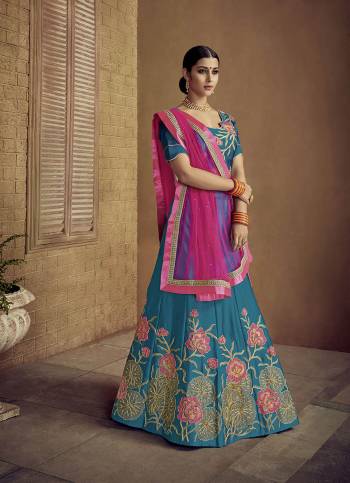 Grab This Designer Rich Looking Lehenga Choli In Blue Color Paired With Contrasting Dark Pink Colored Dupatta. Its Blouse And Lehenga Are Fabricated On Satin Silk Paired With Net Fabricated Dupatta. Buy Now.