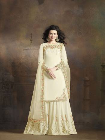 Simple And Elegant Looking Heavy Designer Suit Is Here In Off-White Color. Its Pretty Embroidered Top And Bottom Are Fabricated On Soft Silk Paired With Embroidered Net Fabricated Dupatta. Is Rich Color With Subtle Work Will Earn You Lots Of Compliments From Onlookers. 