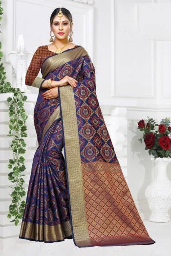 Celebrate This Festive Season Wearing This Designer Silk Based Saree In Navy Blue Color paired With Navy Blue And Red Colored Blouse. This Saree And Blouse Are Fabricated On Patola Art Silk Beautified with Weave All Over. 