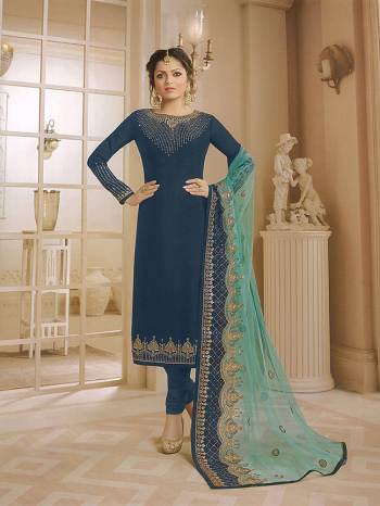 Grab This Pretty Shades Of Blue With This Heavy Designer Straight Suit In Blue Color Paired With Aqua Blue Colored Dupatta. Its Top Is Fabricated On Satin Georgette Paired With Santoon Bottom And Net Fabricated Heavy Embroidered Dupatta. Its Fabrics Are Light Weight And Easy To Carry All Day Long. 