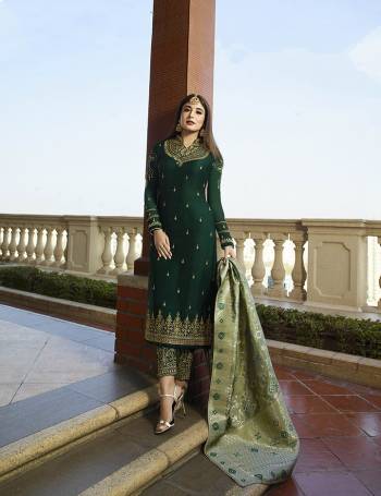 Go With The Shades Of Green With This Heavy Designer Suit In Dark Green Color Paired With Light Green Colored Dupatta. Its Top Is Fabricated On Satin Georgette Paired With Santoon Bottom And Jacquard Silk Fabricated Dupatta. Its Top And Bottom Are Beautified With Heavy Embroidery.