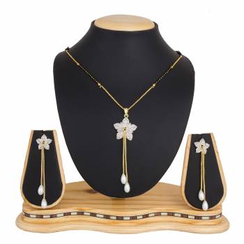 Here Is A New And Unique Patterned Designer Mangalsutra Set In Golden and Silver Color. This Pretty Set Comes A Pretty Pair Of Matching Earrings. It Is Beautified With Attractive Dimaond Work With Unique Designs. Buy Now.