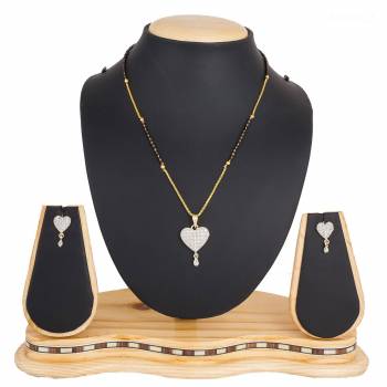 Here Is A New And Unique Patterned Designer Mangalsutra Set In Golden and Silver Color. This Pretty Set Comes A Pretty Pair Of Matching Earrings. It Is Beautified With Attractive Dimaond Work With Unique Designs. Buy Now.