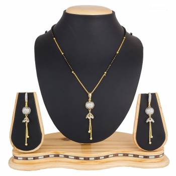 Here Is A New And Unique Patterned Designer Mangalsutra Set In Golden and Silver Color. This Pretty Set Comes A Pretty Pair Of Matching Earrings. It Is Beautified With Attractive Dimaond Work With Unique Designs. Buy Now.