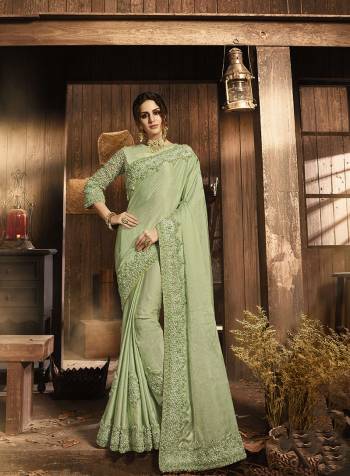 Pretty In Pastels This Summer With This Heavy Designer Saree In Pastel Green Color Paired With Pastel Green Colored Blouse. This Saree Is Fabricated On Soft Silk Paired With Art Silk And Net Fabricated Blouse. This Pretty Saree And Blouse Are Beautified With Attractive Fancy Work. 