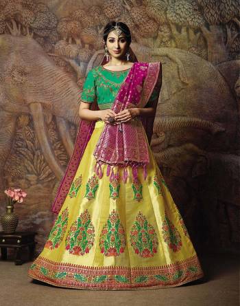 Attract All Wearing This Heavy Designer Lehenga Choli In Green Colored Blouse Paired With Yellow Colored Lehenga And Dark Pink Colored Dupatta. This Silk Based Lehenga Choli Is Beautified With Heavy Weave And Subtle Embroidery. Its Lehenga And Dupatta Are Fabricated On Jacquard Silk Paired With Art Silk Fabricated Blouse. Buy Now.