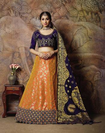 Catch All The Limelight In The Next Wedding You Attend With This Designer Lehenga Choli In Navy Blue Colored Blouse Paired With Contrasting Orange Colored Lehenga And Navy Blue Colored Dupatta. Its Lehenga Are Dupatta Are Fabricated On Jacquard Silk PAired With Art Silk Fabricated Blouse. 