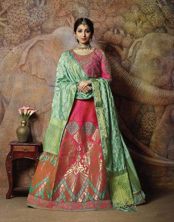 You Will Definitely Earn Lots Of Compliments In This Rich Silk Based Designer Lehenga Choli. Its Blouse Is In Dark Pink Color Paired With Dark Pink Colored Lehenga And Light Green Colored Dupatta. It Is Beautified With Bold Weave And Subtle Embroidery Over The Blouse. Buy This Silk Based Lehenga Choli Now.