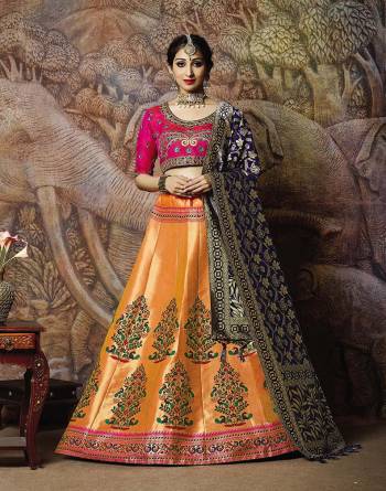 Catch All The Limelight In The Next Wedding You Attend With This Designer Lehenga Choli In Rani Pink Colored Blouse Paired With Contrasting Orange Colored Lehenga And Navy Blue Colored Dupatta. Its Lehenga Are Dupatta Are Fabricated On Jacquard Silk PAired With Art Silk Fabricated Blouse. 