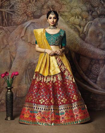 You Will Definitely Earn Lots Of Compliments In This Rich Silk Based Designer Lehenga Choli. Its Blouse Is In Teal Green Color Paired With Maroon Colored Lehenga And Yellow Colored Dupatta. It Is Beautified With Bold Weave And Subtle Embroidery Over The Blouse. Buy This Silk Based Lehenga Choli Now.