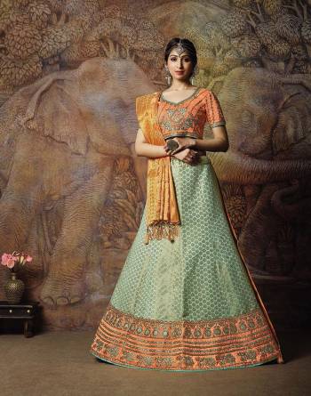 Catch All The Limelight In The Next Wedding You Attend With This Designer Lehenga Choli In Orange Colored Blouse Paired With Contrasting Aqua Blue Colored Lehenga And Golden & Orange Colored Dupatta. Its Lehenga Are Dupatta Are Fabricated On Jacquard Silk PAired With Art Silk Fabricated Blouse. 