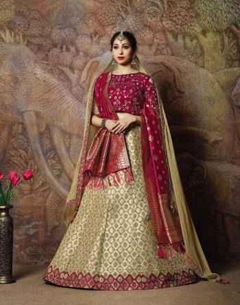 You Will Definitely Earn Lots Of Compliments In This Rich Silk Based Designer Lehenga Choli. Its Blouse Is In Magenta Pink Color Paired With Cream Colored Lehenga And Magenta Pink Colored Dupatta. It Is Beautified With Bold Weave And Subtle Embroidery Over The Blouse. Buy This Silk Based Lehenga Choli Now.