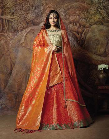 Catch All The Limelight In The Next Wedding You Attend With This Designer Lehenga Choli In Cream Colored Blouse Paired With Contrasting Orange Colored Lehenga And Orange Colored Dupatta. Its Lehenga Are Dupatta Are Fabricated On Jacquard Silk PAired With Art Silk Fabricated Blouse. 