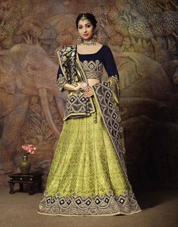 You Will Definitely Earn Lots Of Compliments In This Rich Silk Based Designer Lehenga Choli. Its Blouse Is In Navy Blue Color Paired With Light Green Colored Lehenga And Navy Blue Colored Dupatta. It Is Beautified With Bold Weave And Subtle Embroidery Over The Blouse. Buy This Silk Based Lehenga Choli Now.