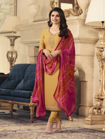 Celebrate This Festive Season Wearing This Designer Straight Cut Suit In Musturd Yellow Color Paired With Contrasting Red And Pink Colored Shaded Dupatta. Buy This Dress Material Now.