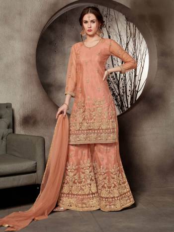 Look Pretty In This Designer Heavy Embroidered Sharara Suit In All Over Dark Peach Color. Its Top, Bottom And Dupatta Are Fabricated On Net Beautified With Heavy Jari Embroidery And Stone Work. Buy This Pretty Suit Now.