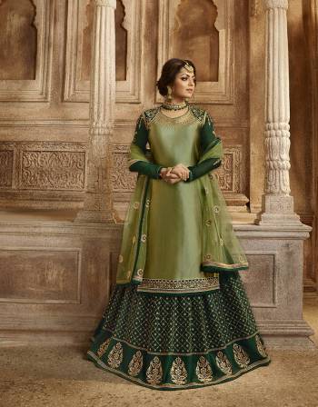 Go With The Pretty Shades Of Green With This Designer Two In One Indo-Western Suit. Its Top, Bottom And Dupatta are In Light Green Color Paired With Dark Green Colored Lehenga. Its Top Is Fabricated On Satin Georgette Paired With Santoon Bottom, Georgette Fabricated Embroidered Lehenga And Net Fabricated Dupatta. Buy Now.