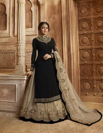 For A Bold And Beautiful Look, Grab This Designer Indo-Western Suit Which You Can Wear Two Ways. Its Top And Bottom are In Black Color Paired With Pale Grey Colored Lehenga And Dupatta. Its Top Is Fabricated On Satin Georgette Paired With Santoon Bottom And Net Fabricated Lehenga And Dupatta. All Its Fabrics Are Light Weight And Easy To Carry Throughout The Gala. 