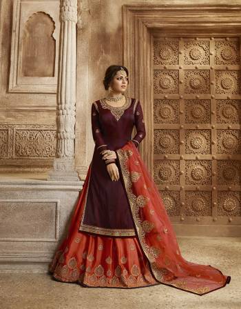 Celebrate This Festive And Wedding Season with Beauty And Comfort Wearing This Designer Indo-Western Suit In  Maroon Colored Top And Bottom Paired With Contrasting Orange Colored Bottom And Dupatta. Its Pretty Embroidered Top IS Satin Georgette Based Paired With Santoon Bottom And Georgette Fabricated Lehenga And Dupatta. 