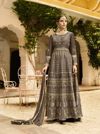 You Will Definitely Earn Lots Of Compliments In This Rich Color Shade With This Designer Floor Length Suit In All Over Dark Grey Color. Its Heavy Embroidered Top Is Fabricated On Art Silk Paired With Santoon Bottom And Chiffon Fabricated Dupatta. Buy Now.