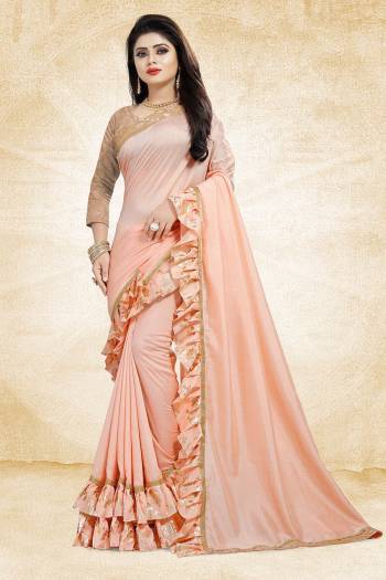 Get Ready For The Upcoming Party And Festives With This Designer Saree In Peach Color Paired With Peach Colored Blouse. This Saree Is Fabricated On Vichitra Silk Paired With Jacquard Silk Fabricated Blouse. It Has Very Attractive Foil Printed Frill And Lace Borders. Buy Now.