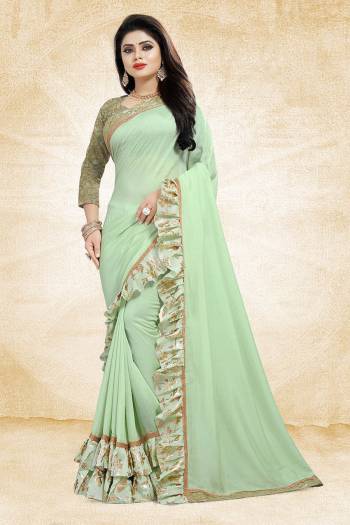 Get Ready For The Upcoming Party And Festives With This Designer Saree In Pastel Green Color Paired With Pastel Green Colored Blouse. This Saree Is Fabricated On Vichitra Silk Paired With Jacquard Silk Fabricated Blouse. It Has Very Attractive Foil Printed Frill And Lace Borders. Buy Now.