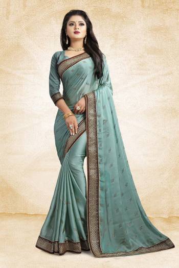 Flaunt Your Rich And Elegant Taste Wearing This Designer Saree In Steel Blue Color Paired With Steel Blue Colored Blouse. This Saree Is Fabricated On Satin Georgette Paired With Art Silk Fabricated Blouse. It Is Beautified With Heavy Embroidered Lace Border And Stone Work Butti Pattern Over The Saree. 