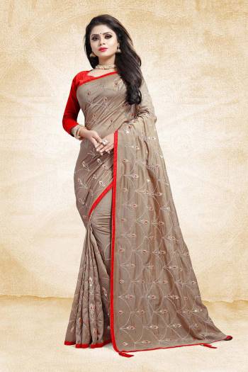 Get Ready For The Upcoming Wedding And Festive Season With This Heavy Embroidered Designer Saree In Beige Color Paired With Contrasting Red Colored Blouse. This Saree And Blouse are Silk Based Beautified With Embroidery All Over The Saree.