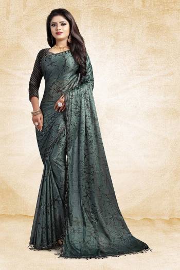 Here Is A Very Pretty And elegant Looking Designer Saree In Teal Green Color Paired With Black Colored Blouse For Party Wear. This Saree And Blouse Are Based On Fancy China Fabric Beautified With Lace Borders. Also It Is Durable, Easy To Drape And Carry All Day Long. 